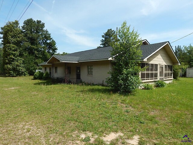 7085 US Highway 341 S, Roberta, GA 31078 - back of house featuring a shingled roof, a sunroom, and a yard