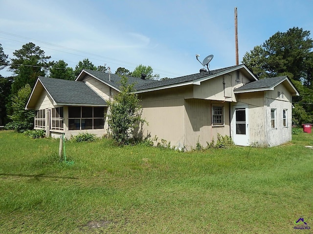 7085 US Highway 341 S, Roberta, GA 31078 - back of house with a sunroom, a lawn, and roof with shingles