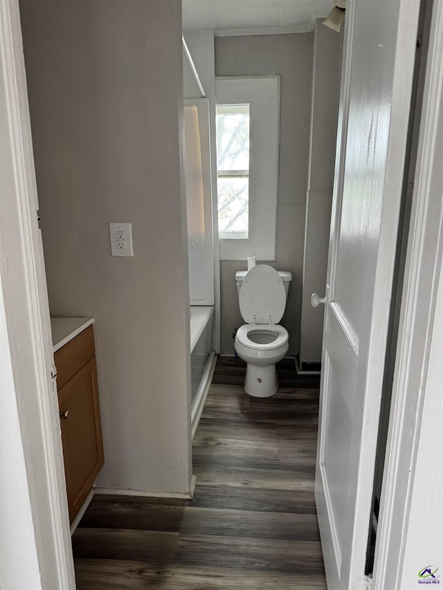 full bath with wood finished floors, vanity, toilet, a bathtub, and a shower