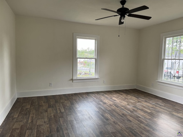 unfurnished room featuring dark wood-type flooring, ceiling fan, and baseboards