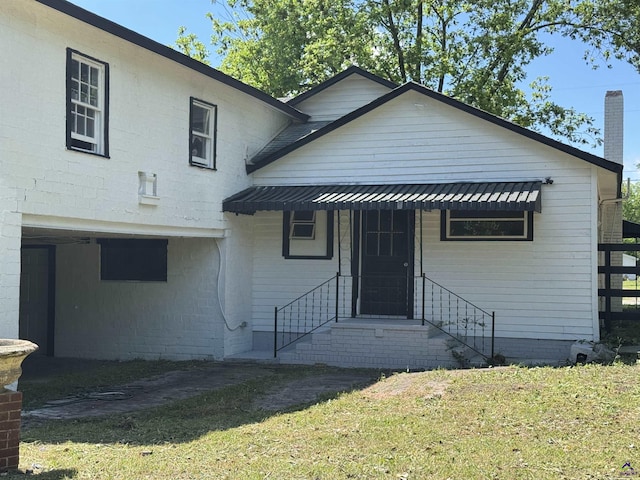 view of front of property featuring a front lawn and a chimney