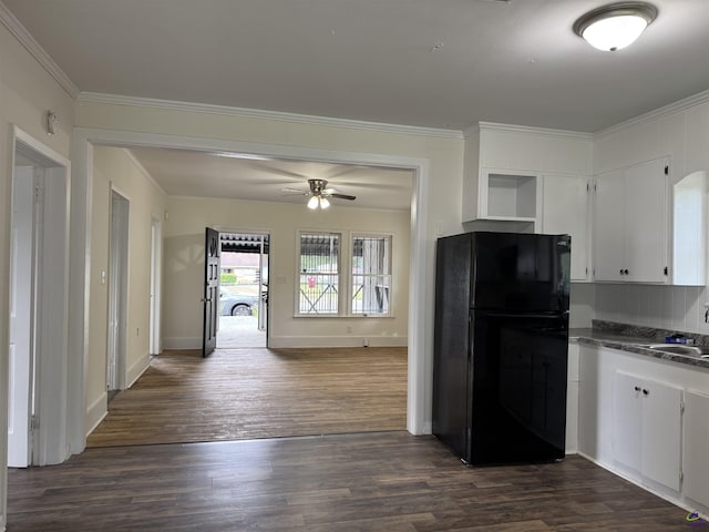 kitchen with freestanding refrigerator, dark countertops, a ceiling fan, dark wood finished floors, and white cabinets