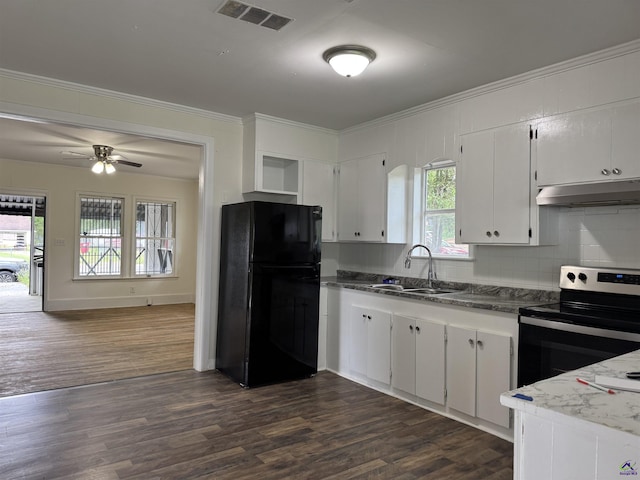 kitchen featuring freestanding refrigerator, under cabinet range hood, a sink, stainless steel electric stove, and crown molding