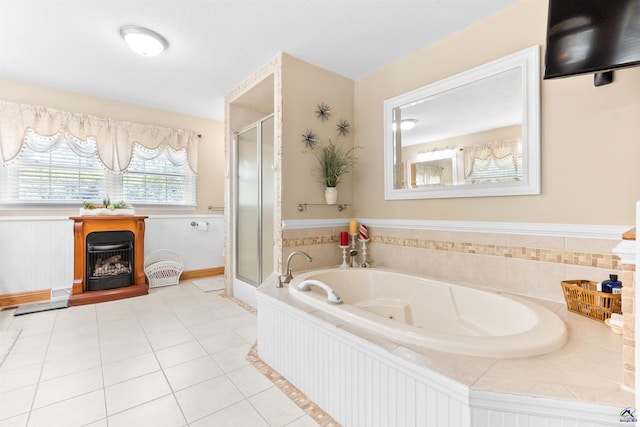 full bath with a stall shower, a jetted tub, and tile patterned floors