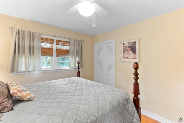bedroom featuring a closet, wood finished floors, baseboards, and a ceiling fan