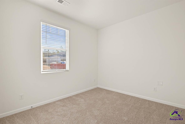empty room with light carpet and baseboards