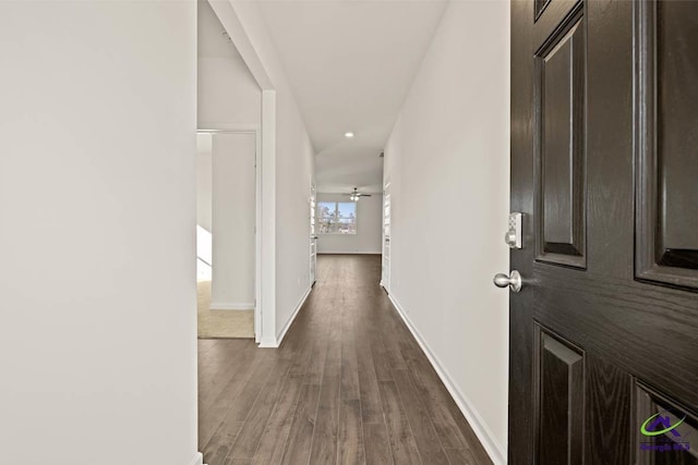 hall featuring wood finished floors, baseboards, and recessed lighting