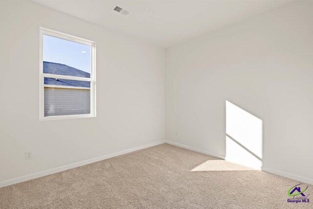 carpeted empty room with baseboards
