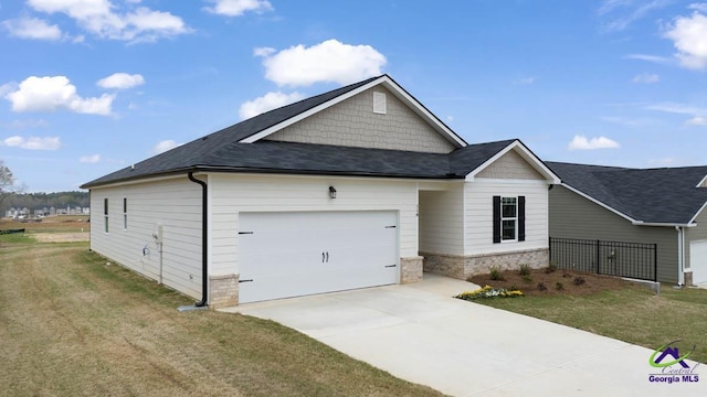 view of front of house with a garage, a front lawn, driveway, and a shingled roof
