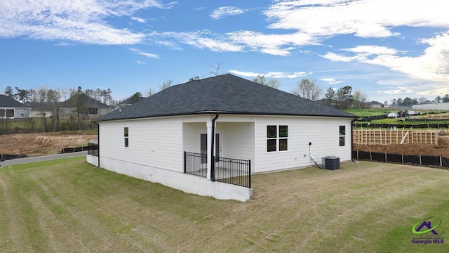 back of property with roof with shingles