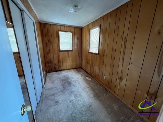 726 Mcarthur Blvd, Warner Robins, GA 31093 - unfurnished bedroom with wood walls, baseboards, and carpet