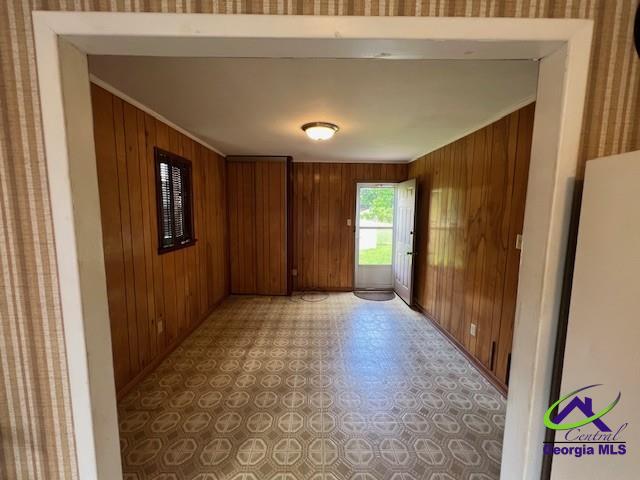 726 Mcarthur Blvd, Warner Robins, GA 31093 - spare room featuring wooden walls, crown molding, light flooring, and baseboards