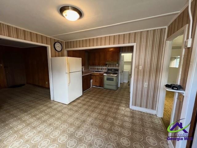 726 Mcarthur Blvd, Warner Robins, GA 31093 - kitchen with freestanding refrigerator, range with gas cooktop, wallpapered walls, light countertops, and light floors