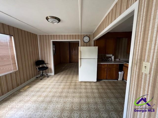 726 Mcarthur Blvd, Warner Robins, GA 31093 - kitchen featuring freestanding refrigerator, wallpapered walls, light countertops, baseboards, and light floors
