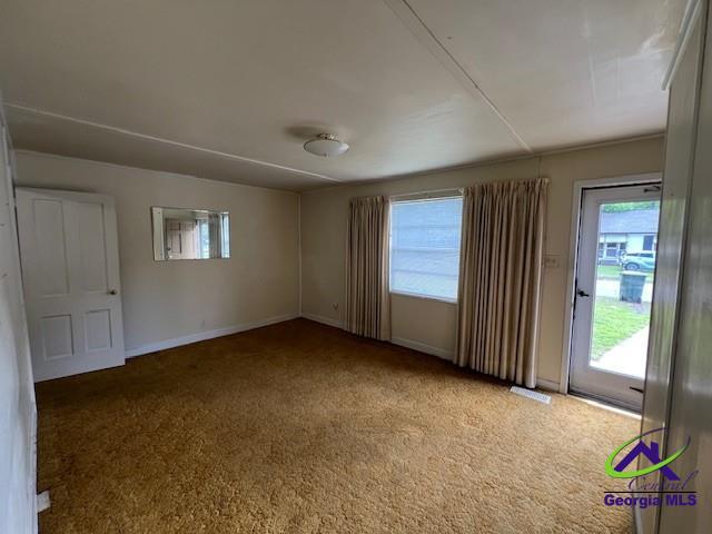726 Mcarthur Blvd, Warner Robins, GA 31093 - spare room featuring healthy amount of natural light, carpet, and baseboards