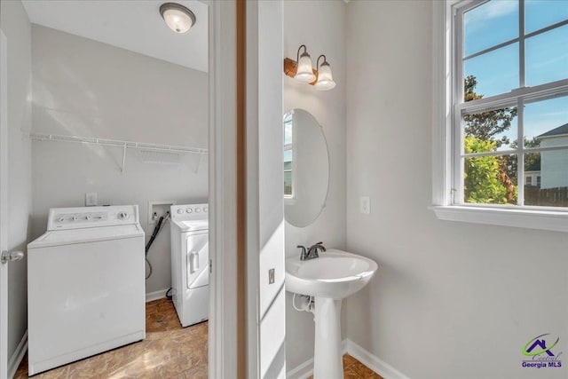 212 Raleigh Dr, Warner Robins, GA 31088 - bathroom featuring independent washer and dryer, baseboards, and a sink