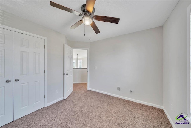 212 Raleigh Dr, Warner Robins, GA 31088 - unfurnished bedroom with carpet floors, baseboards, a ceiling fan, and a closet