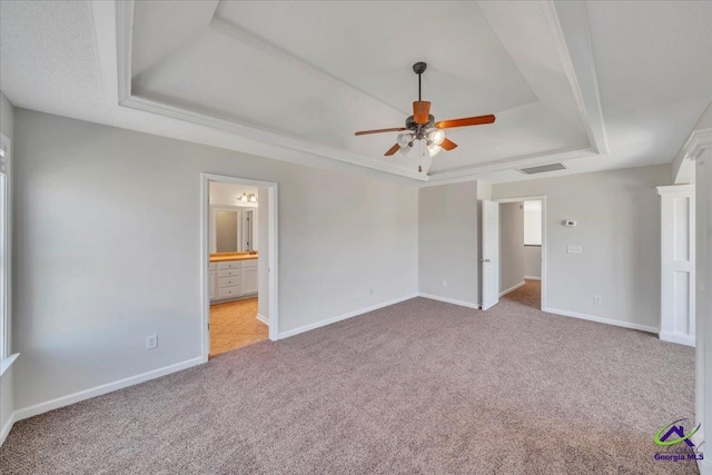 212 Raleigh Dr, Warner Robins, GA 31088 - unfurnished bedroom featuring a raised ceiling, carpet flooring, and baseboards