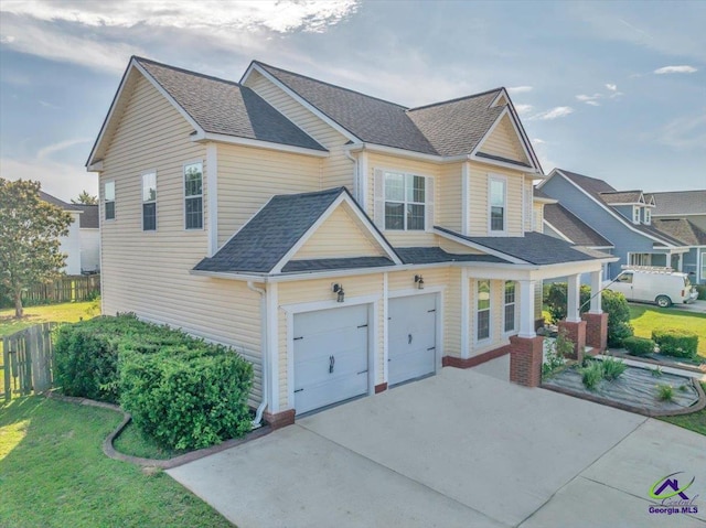 212 Raleigh Dr, Warner Robins, GA 31088 - view of front facade with concrete driveway, an attached garage, and roof with shingles