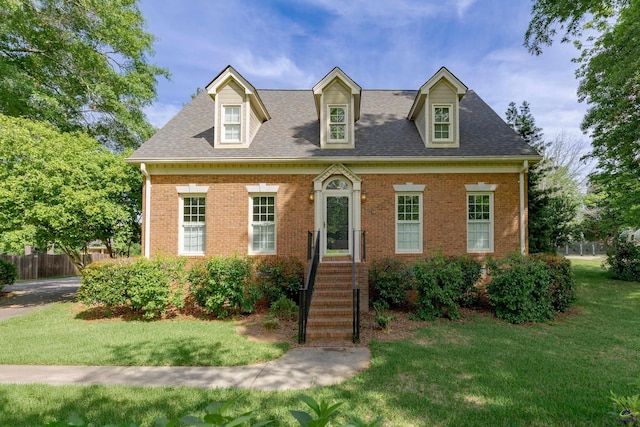 view of front of house featuring brick siding and a shingled roof