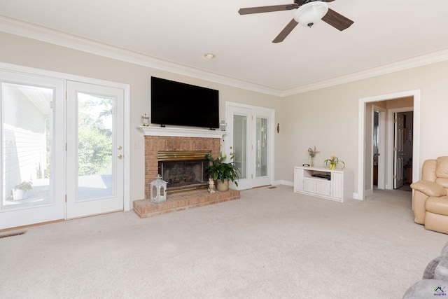 carpeted living room with ornamental molding, a ceiling fan, a fireplace, and baseboards