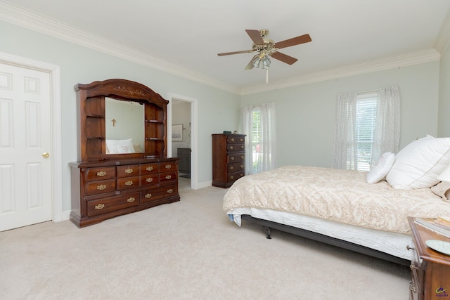 bedroom featuring ornamental molding, light colored carpet, ceiling fan, and ensuite bathroom