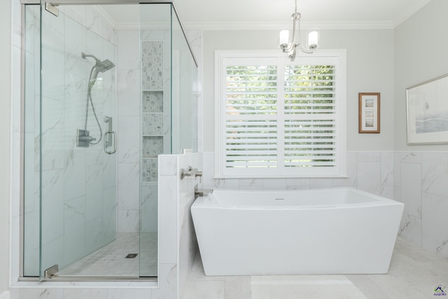 bathroom featuring crown molding, a stall shower, a freestanding bath, a chandelier, and tile walls