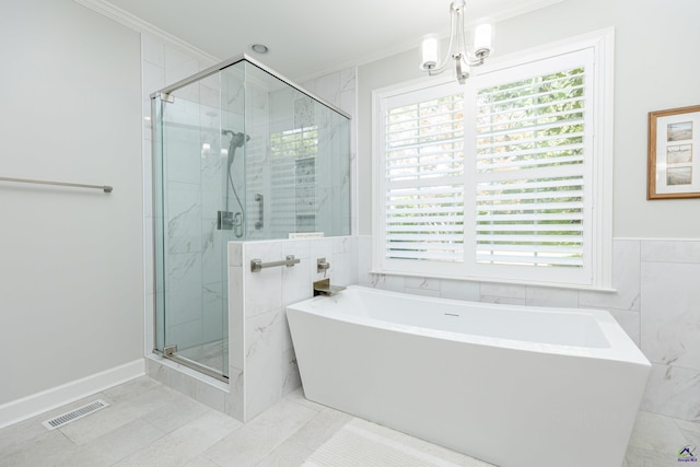 bathroom featuring ornamental molding, a shower stall, tile walls, a freestanding tub, and tile patterned flooring