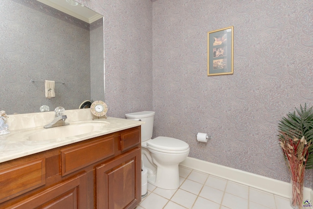 half bath featuring tile patterned floors, toilet, vanity, and wallpapered walls