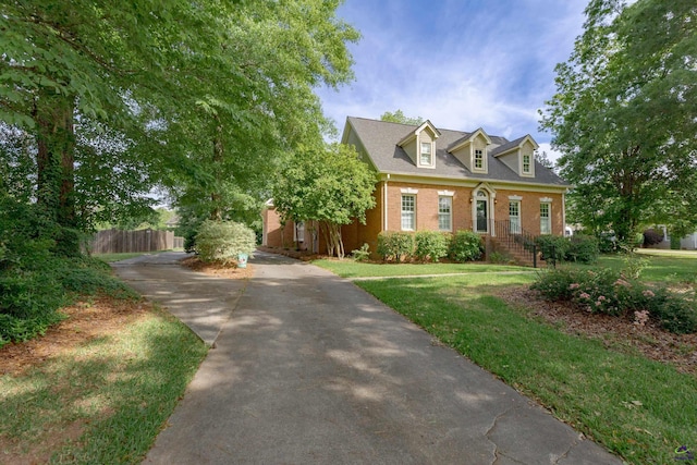 view of front of home with brick siding and concrete driveway