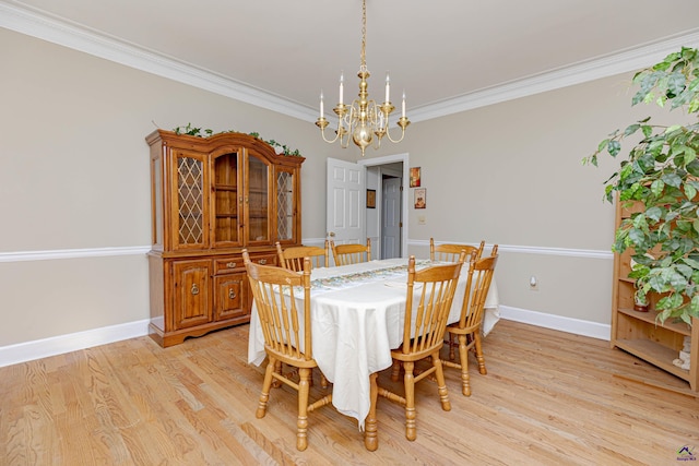 dining area with a chandelier, ornamental molding, light wood finished floors, and baseboards