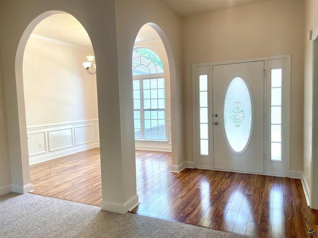 1187 Camden Ct, Warner Robins, GA 31088 - entryway with arched walkways, wood finished floors, and crown molding