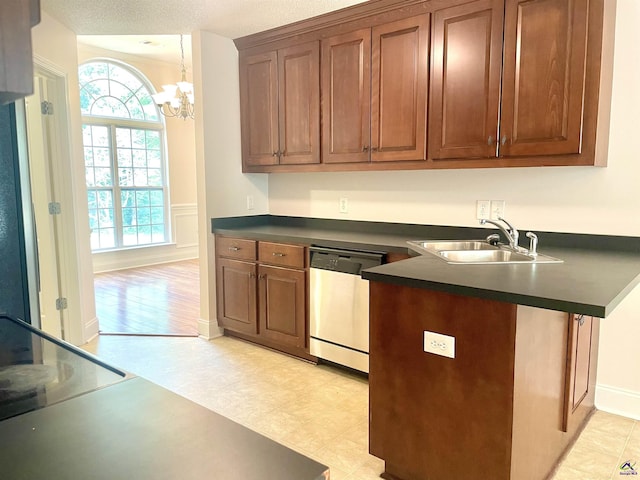 1187 Camden Ct, Warner Robins, GA 31088 - kitchen featuring dishwasher, a sink, dark countertops, a chandelier, and a peninsula