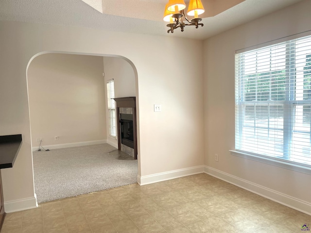 1187 Camden Ct, Warner Robins, GA 31088 - unfurnished dining area featuring plenty of natural light, arched walkways, a chandelier, and a tiled fireplace