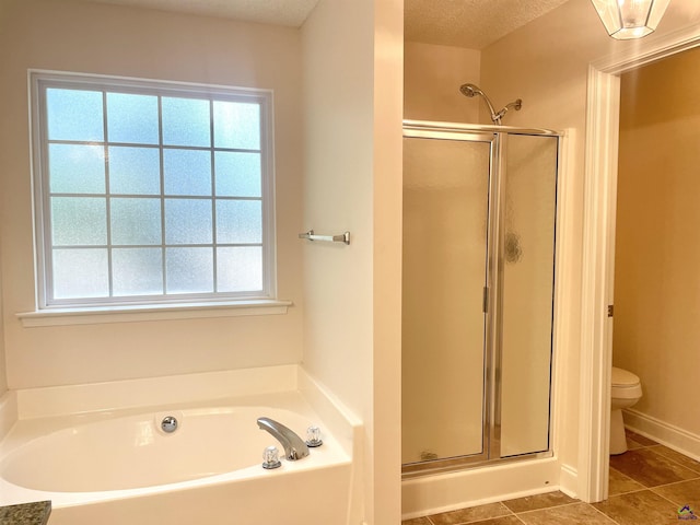 1187 Camden Ct, Warner Robins, GA 31088 - full bath with a shower stall, a garden tub, plenty of natural light, toilet, and a textured ceiling