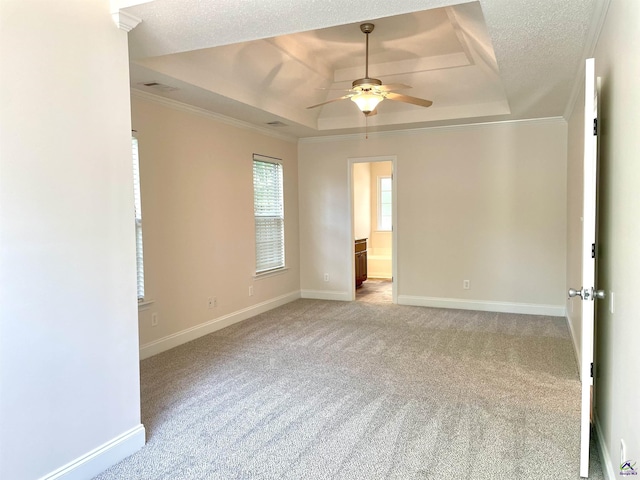1187 Camden Ct, Warner Robins, GA 31088 - unfurnished room with a tray ceiling, ceiling fan, light colored carpet, baseboards, and crown molding