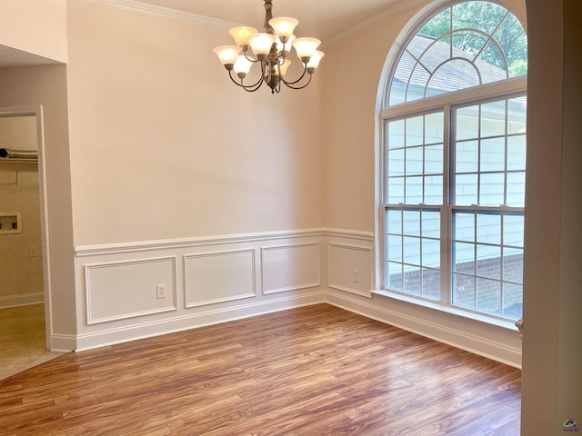 1187 Camden Ct, Warner Robins, GA 31088 - spare room featuring ornamental molding, a chandelier, wood finished floors, and a wainscoted wall