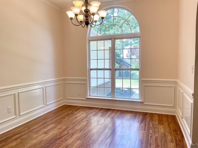 1187 Camden Ct, Warner Robins, GA 31088 - empty room with a chandelier, dark wood-type flooring, ornamental molding, wainscoting, and a decorative wall