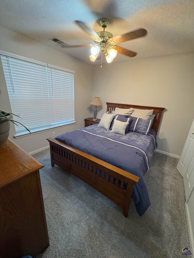 bedroom with carpet, a textured ceiling, a ceiling fan, and baseboards