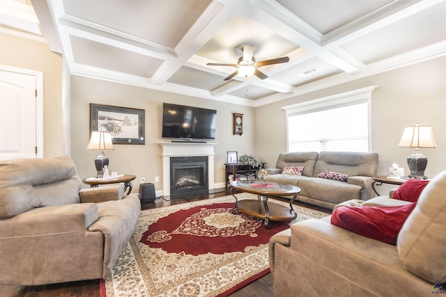 living room featuring wood finished floors, a fireplace with flush hearth, coffered ceiling, a ceiling fan, and beamed ceiling