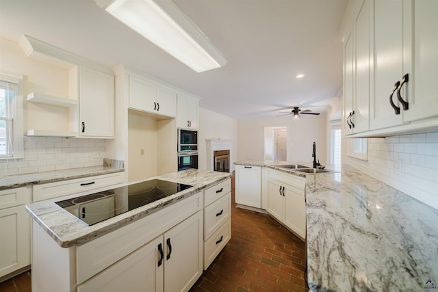 100 Cliff Pointe Pointe, Warner Robins, GA 31088 - kitchen with a sink, black electric cooktop, brick floors, a ceiling fan, and white cabinetry