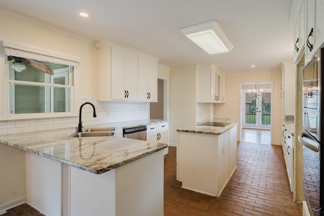 100 Cliff Pointe Pointe, Warner Robins, GA 31088 - kitchen with a sink, stainless steel dishwasher, brick flooring, light stone counters, and a peninsula
