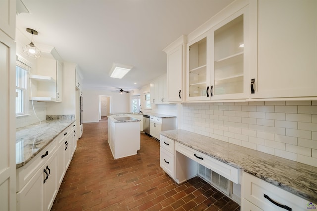 100 Cliff Pointe Pointe, Warner Robins, GA 31088 - kitchen with stainless steel dishwasher, brick floors, glass insert cabinets, white cabinets, and decorative backsplash