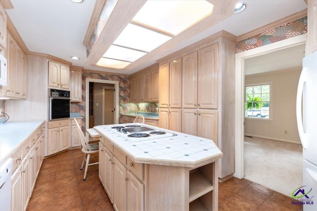 kitchen featuring white appliances, tile counters, light brown cabinets, backsplash, and recessed lighting