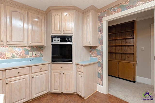 kitchen featuring oven, wallpapered walls, light countertops, baseboards, and light tile patterned floors