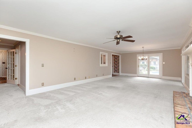 unfurnished living room with a ceiling fan, light colored carpet, a chandelier, ornamental molding, and baseboards