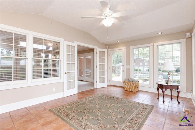 sunroom featuring french doors and vaulted ceiling