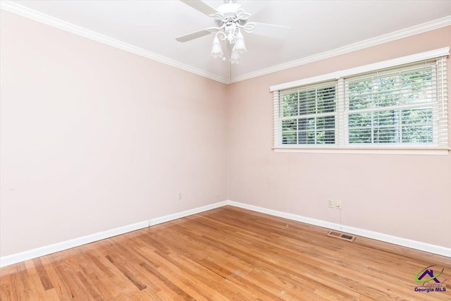 unfurnished room with baseboards, light wood-style flooring, ornamental molding, and a ceiling fan