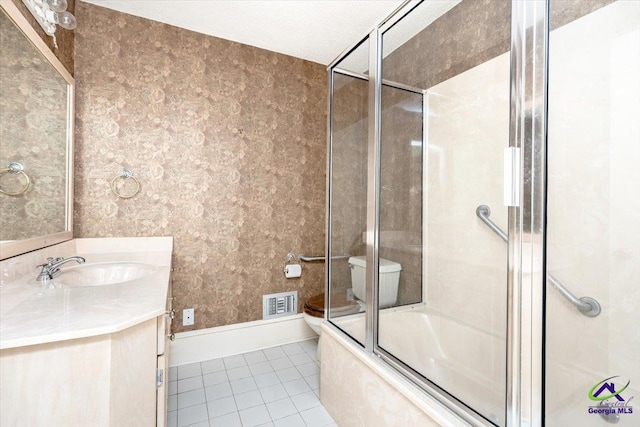 full bathroom featuring tile patterned flooring, vanity, toilet, and enclosed tub / shower combo