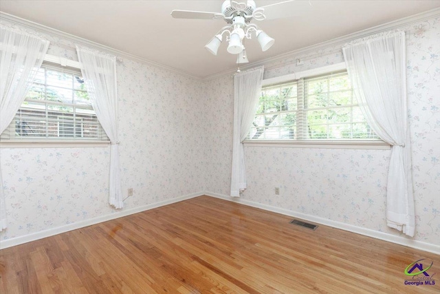 unfurnished room with wood finished floors, ceiling fan, and ornamental molding